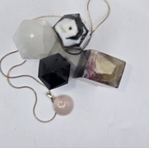 Geometric Pendant Necklace with Rose Quartz and Black Accents On A Silver Chain.